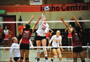 Makenzie Filer, 12, spikes it against Southern Utah University on Sept. 15.
