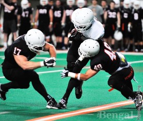 Christian Gines, 49, goes in for a tackle on Cameron Richmond, 5.