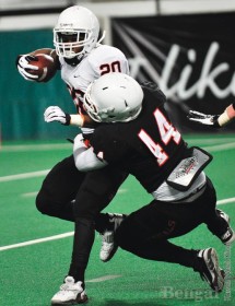 Jake Pele, 44, tackles Aaron Prier, 20, during a spring scrimmage.