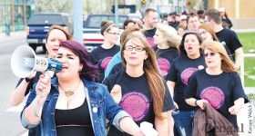 Student Jessica Milford, left, leads participants in the Take Back the Night march, Friday, May 3.