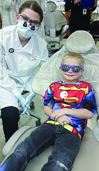 Alcy Clark and her patient are all smiles during a teeth cleaning at the Give Kids a Smile event.
