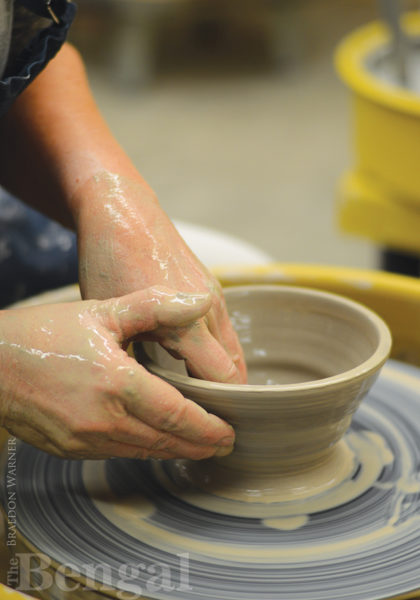 hands spinning pottery