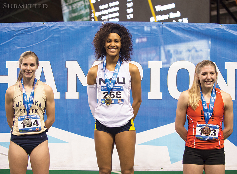 Women track winners with medals.