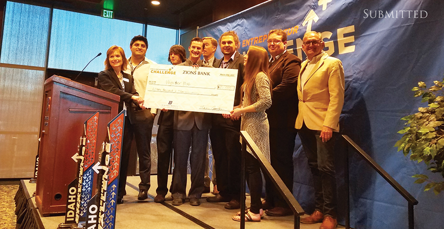 ISU's first place winner accepting large novelty check on stage.