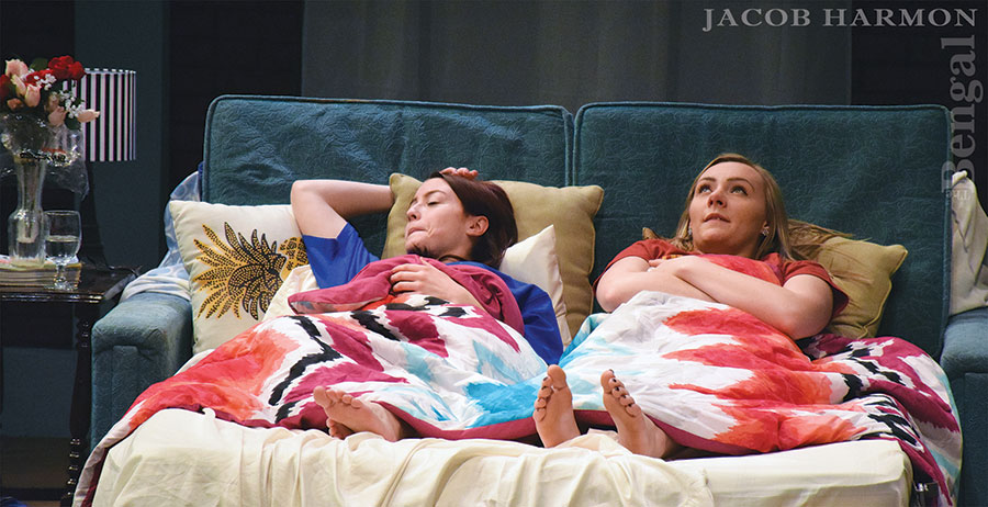 Stop Kiss actors lying in a bed on set.