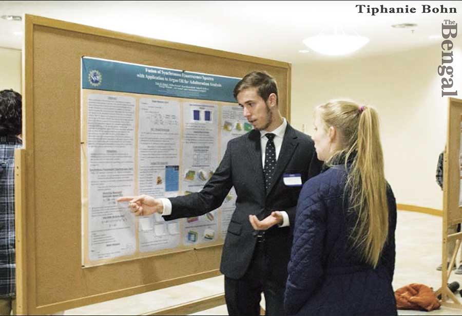 Student presenting research poster