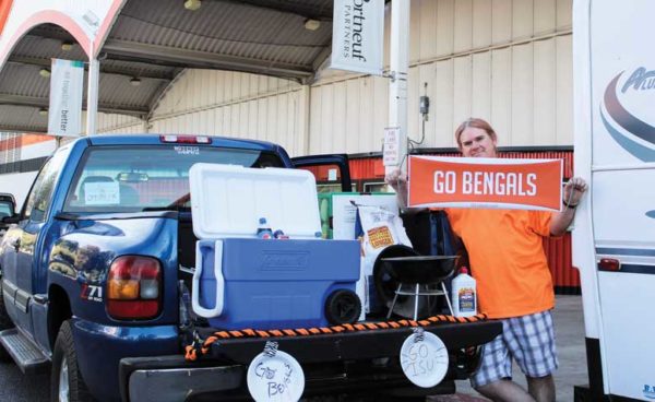 1 person standing by truck holding "Go Bengals" sign