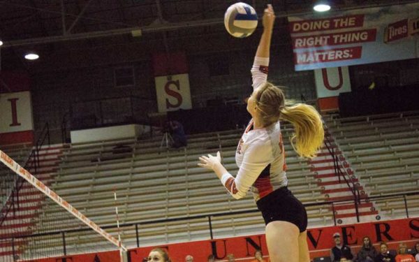 ISU Volleyball player jumps up to spike ball.
