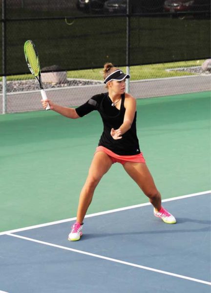 Hristina Cvetkovic returns tennis ball.