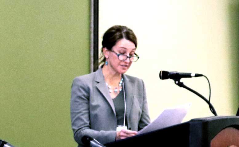 Yolonda Youngs (Ph. D.), from the Department of Global Studies, stands at podium.