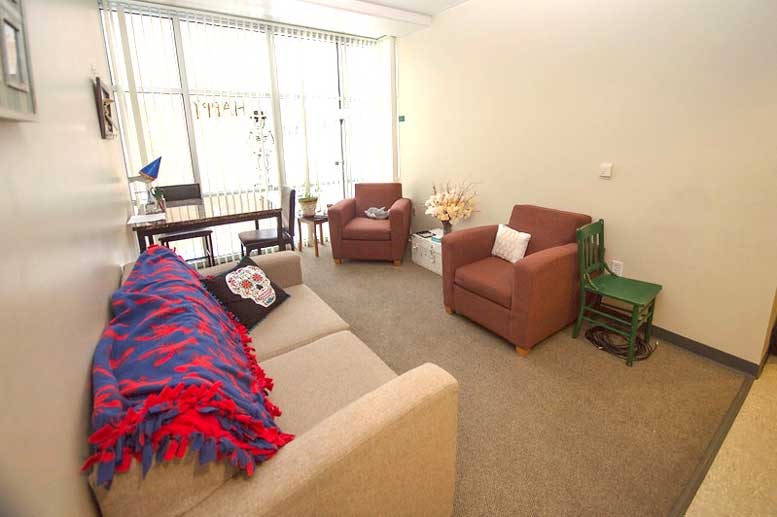 Common area in Rendezvous suite with couch and two chairs.