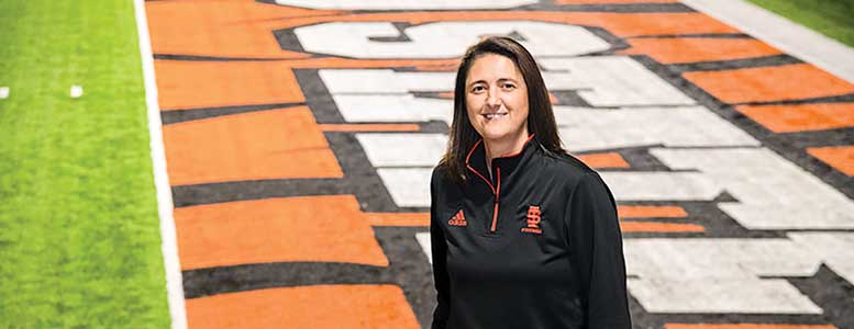 Pauline Thiros stands on ISU football field