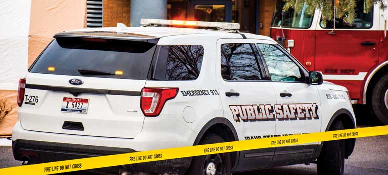 Public Safety car behind caution tape.