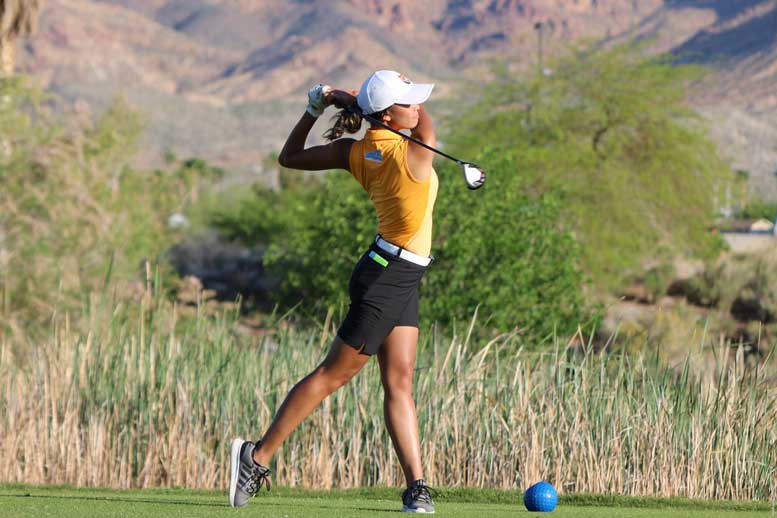 Female golfer swings