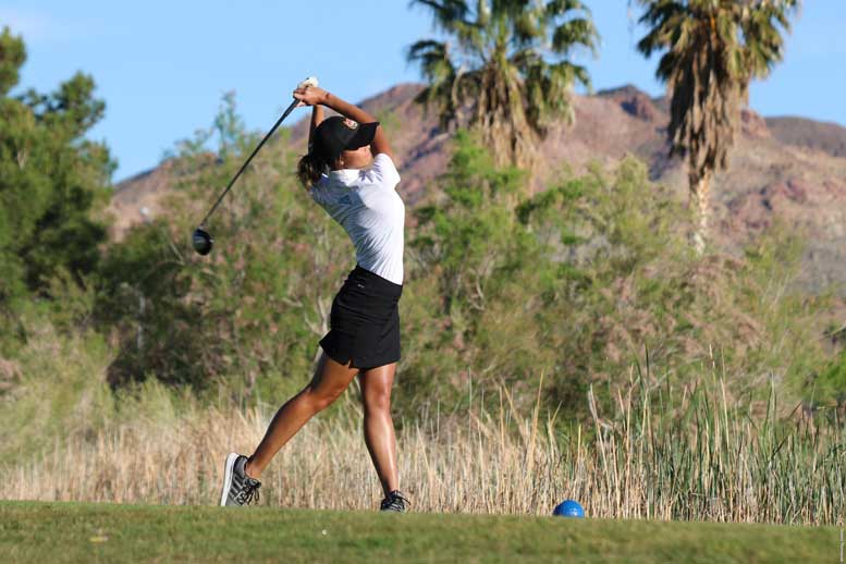 Golfer follows through swing