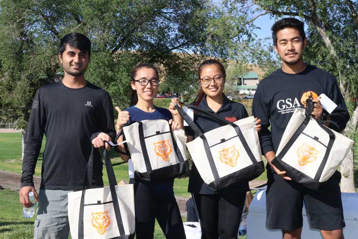 Participants pose with bags