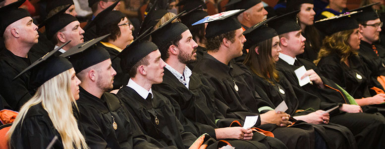 ISU graduates sit in caps and gowns