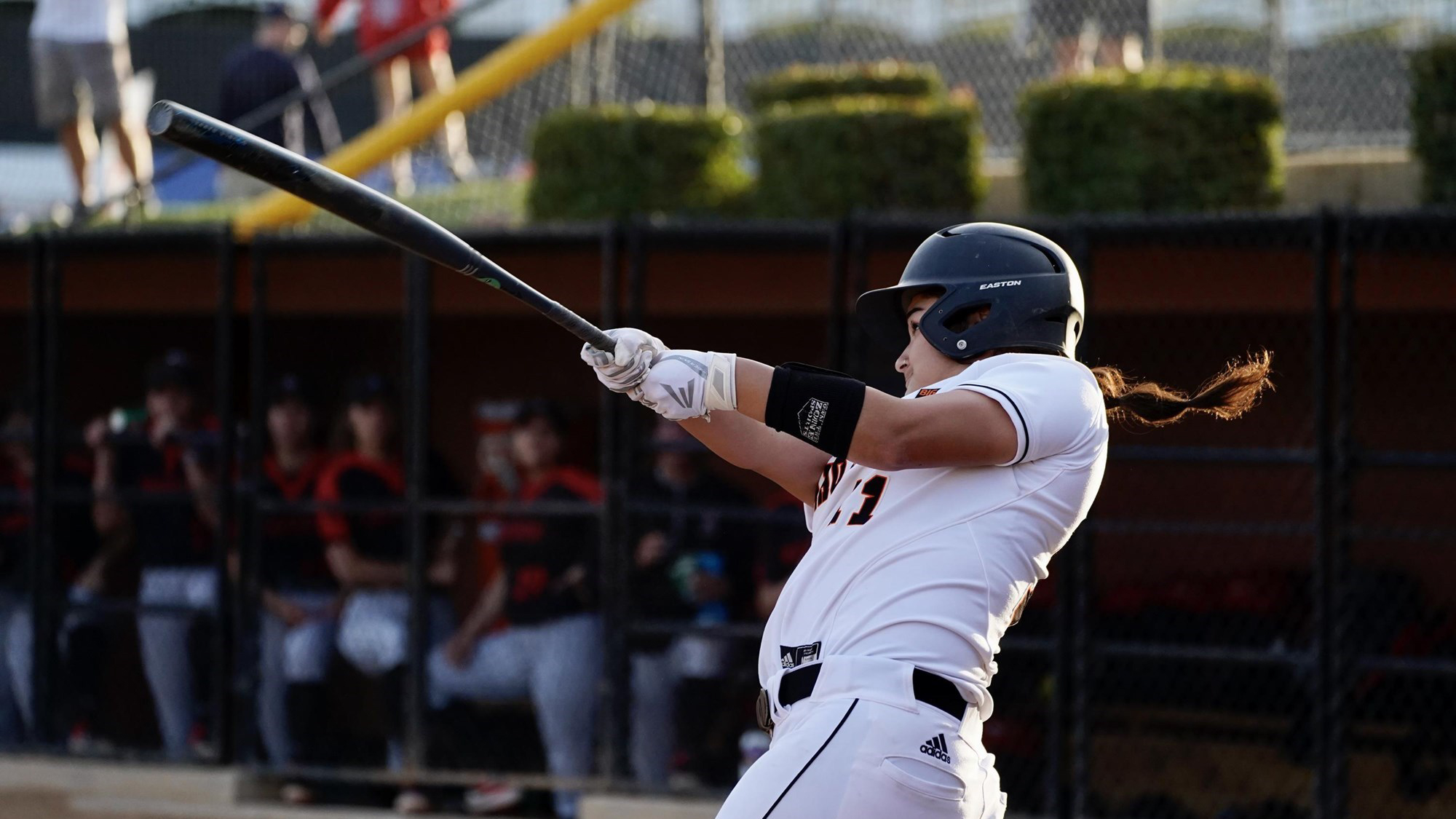 ISU softball player swings bat