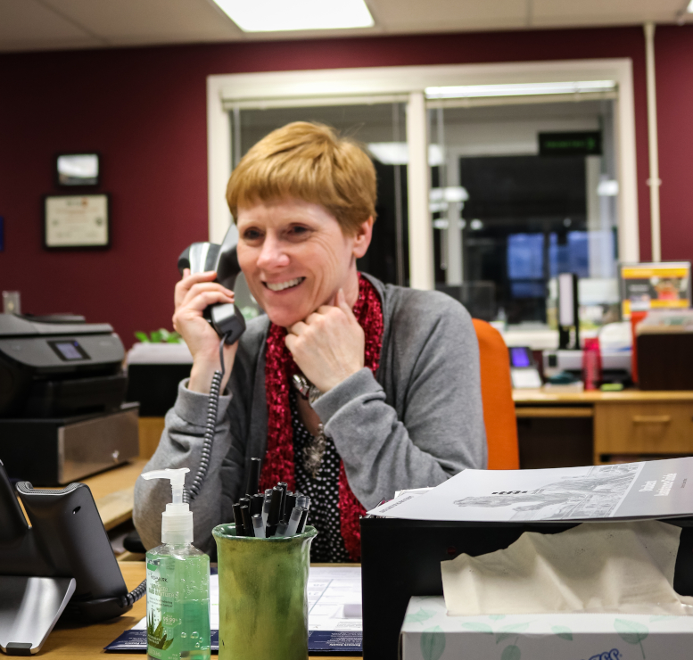 Woman speaks on phone in office