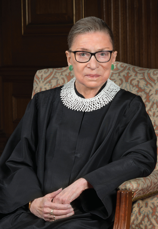 Ruth Bader Ginsburg sitting in chair wearing judge's robes and collar.