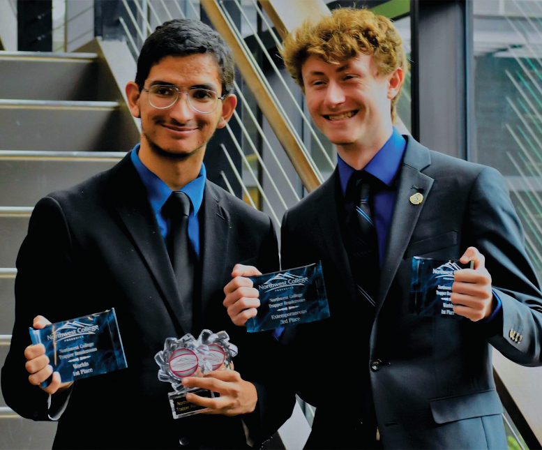 Featured: Joseph Tyler and Kaden Marchetti stand together, smiling, holding awards