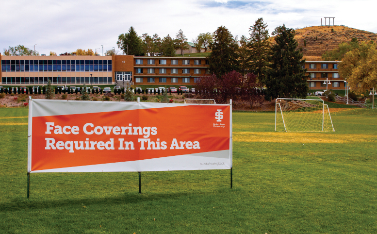 Photo of sign on Cadet Field reading "Face Coverings Required In This Area"