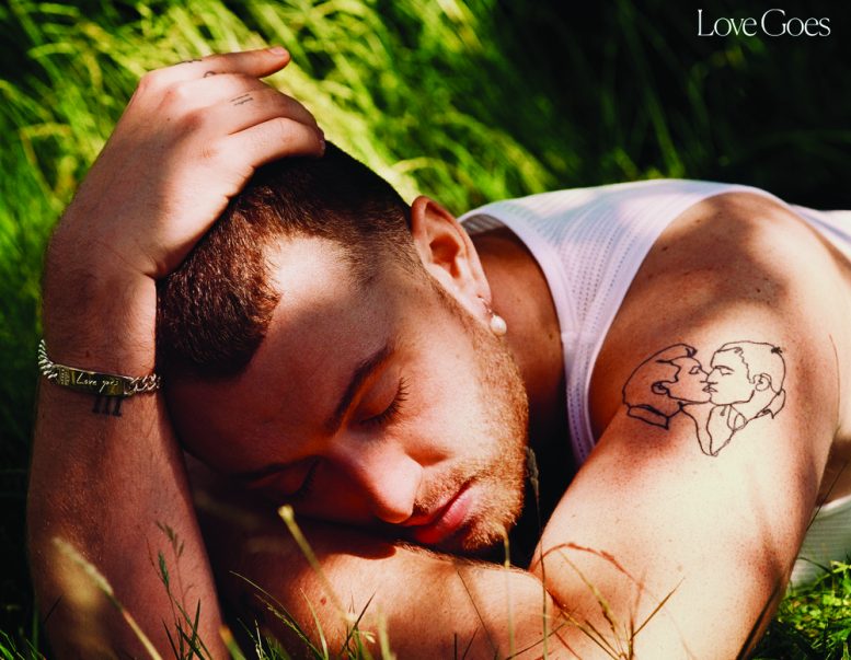 Cover for Sam Smith's "Love Goes" album cover. Image shows Smith laying on their stomach on grass with their eyes shut and arms folded.