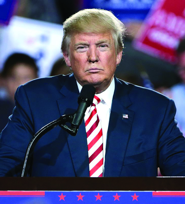 Donald Trump stands at podium.