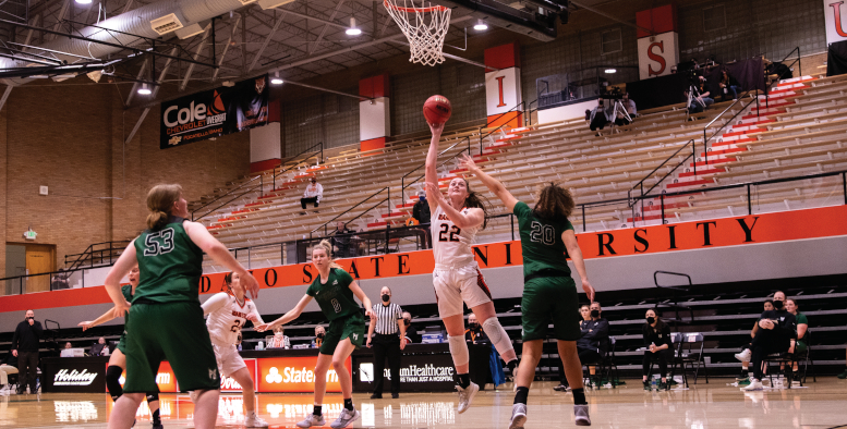 ISU player goes for the layup while Vikings players attempt to block her