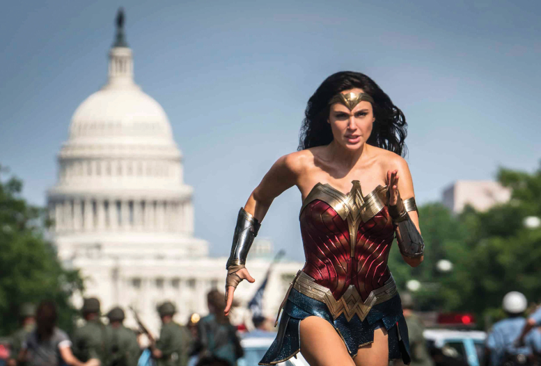 Wonder Woman runs toward camera with US Capitol in background