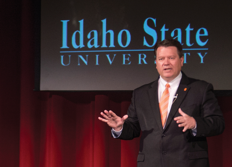 President Saterlee stands on stage speaking to audience.