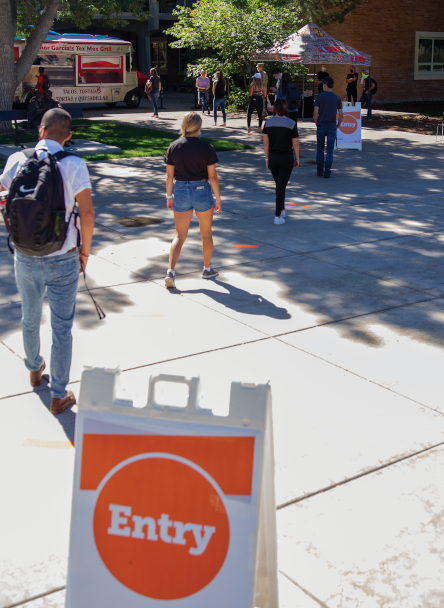 ISU students stand in socially distanced line outside