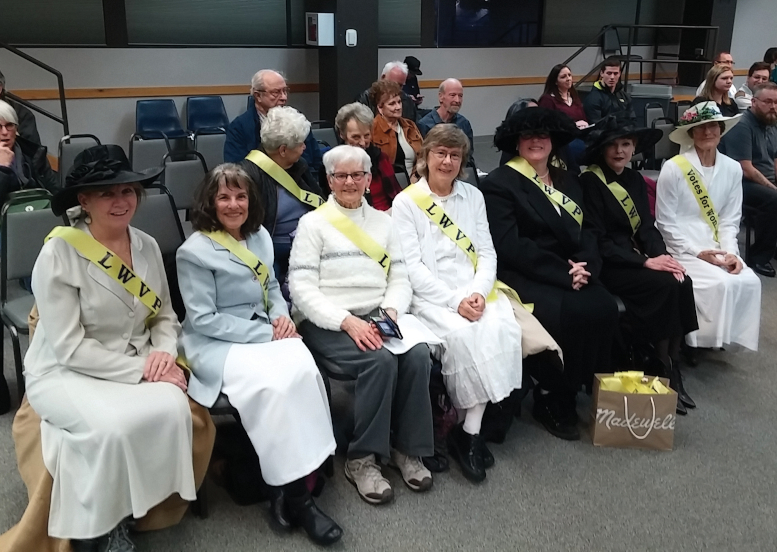 A gtroup photo of women dressed up in historical dress.