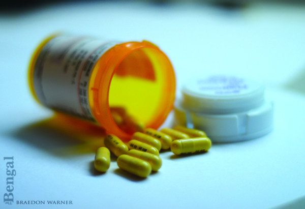 Prescription bottle with pills spilling out