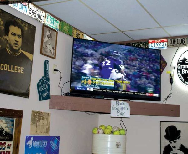 Football game plays on TV in corner of Goodies.