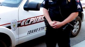 Picture of lower half of Public Safety officer in front of Public Safety patrol car.