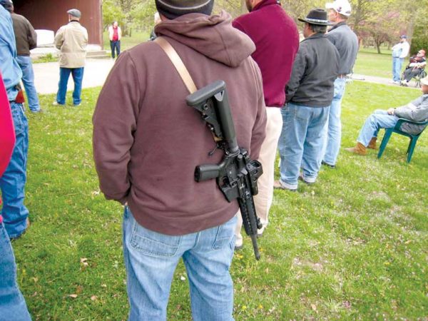 Man with gun strapped across back