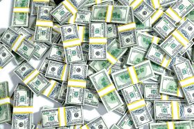 Bundles of 100 dollar bills lay scattered.